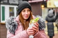 Street food. young woman holding greek meat gyros with tzatziki sauce, vegetables, feta cheese and french fries and eating oudoor Royalty Free Stock Photo