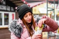 Street food. young woman holding greek meat gyros with tzatziki sauce, vegetables, feta cheese and french fries and eating oudoor Royalty Free Stock Photo