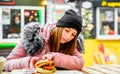 Street food. young woman holding juicy burger and eating oudoor