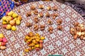 Street foods in Lagos Nigeria; kola nuts and bitter kola laid out on a basket by the roadside.