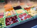 Street Fruits with Steam for Sale. Pomegranate, Watermelon, Kiwi, Mandarin, Pineapple and Steamed Blood Orange in Vapor Fog