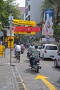 A busy crowded road with private transportation bicycles, motorcycles and small cars in Male, Maldives