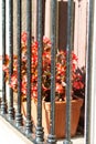 Street garden planter with flowers behind bars on the window Royalty Free Stock Photo