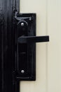 Street gate with corrugated sheet covering and black door knob and lock close-up Royalty Free Stock Photo