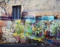 street graffiti art murals on old grunge wall with single window in old center of Odessa, Ukraine