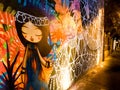 Street graffiti of a cartoon girl on an illuminated wall in Sao Paulo