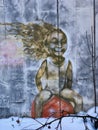 Street graffiti of a girl on a red ball