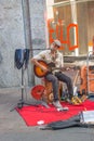 Street guitar player and singer in historical downtown of Milan, Italy