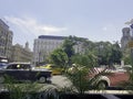 Street of Havana with cars and Gran Hotel Manzana Kempinski in background