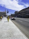 Street of Havana with cars, residential buildings and Great Theatre in background -