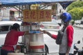 Street hawker sells soya milk on the street in Seremban, Malaysia