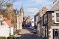 Street in the historic village of Falkland in Scotland, home of Falkland Palace. Cars parked along the road