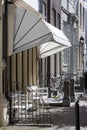 Street with historical buildings and an awning