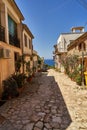 Street between houses facing the sea on a sunny morning