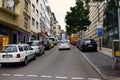 Street with houses of mid-20th century and modern cars