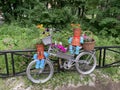 Street installation. Bicycle with flowers basket and pots characters near the fence Royalty Free Stock Photo