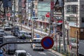 A street in a Japanese city with a dense building of tall modern houses and cars driving along a wide road. Tokyo, Japan, 2017-04- Royalty Free Stock Photo