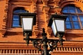 Street lamp against the building from a red brick