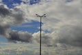 Street lamp against the sky with volumetric clouds Royalty Free Stock Photo