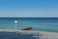 Street lamp on the beach against the background of the sea Royalty Free Stock Photo