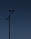 Street lamp and blue sky and moon Royalty Free Stock Photo