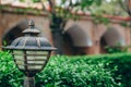 Street lamp close up on a background of plants