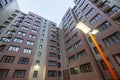 Street lamp in the courtyard of a multi-storey modern house in the evening