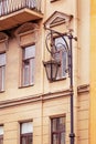 Elegant vintage street lamp near the facade of the old house. Royalty Free Stock Photo