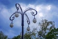 Street lamp with four white teardrop-shaped plafonds