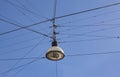 Street lamp hanging on wires against blue sky background Royalty Free Stock Photo