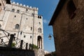 Street lamp hangs from corner of typical old stone European building against blue sky Royalty Free Stock Photo