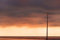 Street lamp, heavy dramatic clouds and bright sky. Royalty Free Stock Photo