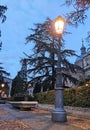 street lamp lit at dusk in a park in Salamanca, Royalty Free Stock Photo