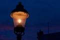 Street lamp at night against blue sky