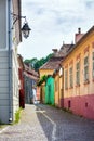 Street lamp on old stone paved street with colored house from Si Royalty Free Stock Photo