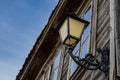 Retro street lamp with patterns on an old wooden house Royalty Free Stock Photo