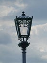 Street lamp on the lamp post against cloudy sky against cloudy blue sky Royalty Free Stock Photo