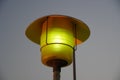 Street Lamp post with the evening skyline view. Outdoor light fixture with sky background. A single hooded street light