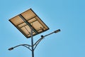 Street lamp powered with a solar panel battery against blue sky.  Alternative energy and save ecology concept Royalty Free Stock Photo