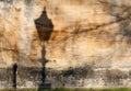 Street lamp shadow on old stone wall texture Royalty Free Stock Photo