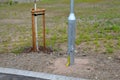 Street lamp by the sidewalk or on train platform with a tilting mast. the galvanized tube of lamp has a hinge in the lower part th