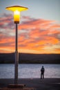 Street lamp and a silhouette at sunset Royalty Free Stock Photo