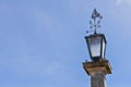 Street lamp with wind direction indicator in form of a sail ship