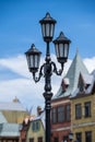 Street lamppost against the old buildings background. Classic victorian street lamps on an old fashioned iron lamp post set Royalty Free Stock Photo