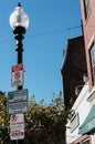 Street lamppost and signage seen in a parking area in downtown Boston.