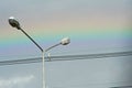 Street lampposts and rainbow