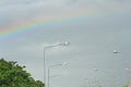 Street lampposts and rainbow