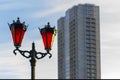 Street lamps twin with orange glass in the afternoon against the background of a high-rise residential building under construction Royalty Free Stock Photo