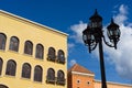 Street lamps with yellow and red buildings on blue sky Royalty Free Stock Photo