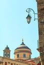 Street landern in Bergamo, Italy with the Bell tower and dome of Cathedral, Upper Town, on the background